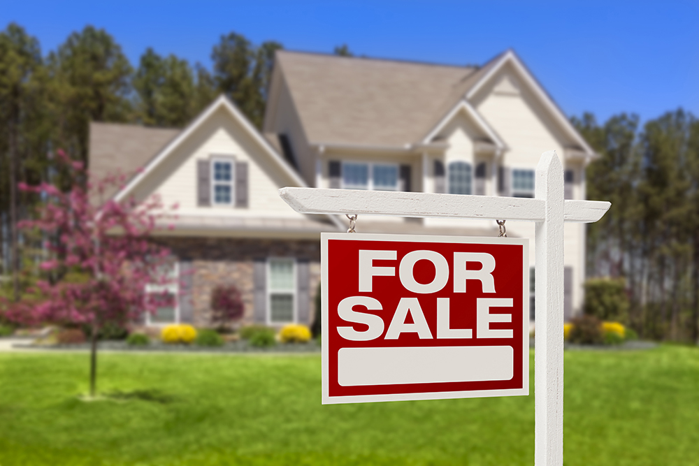 For sale sign in front of a house after home inspection services were preformed 