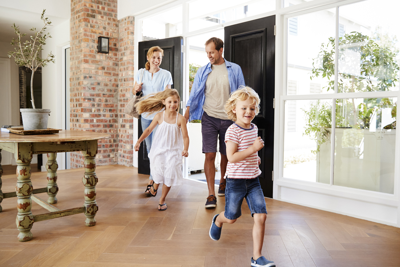 Young family walking into their new house after a home inspection