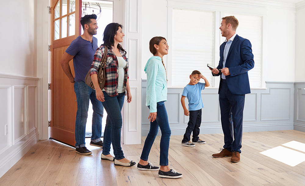 Realtor Showing Family Around New House After A Home Inspection