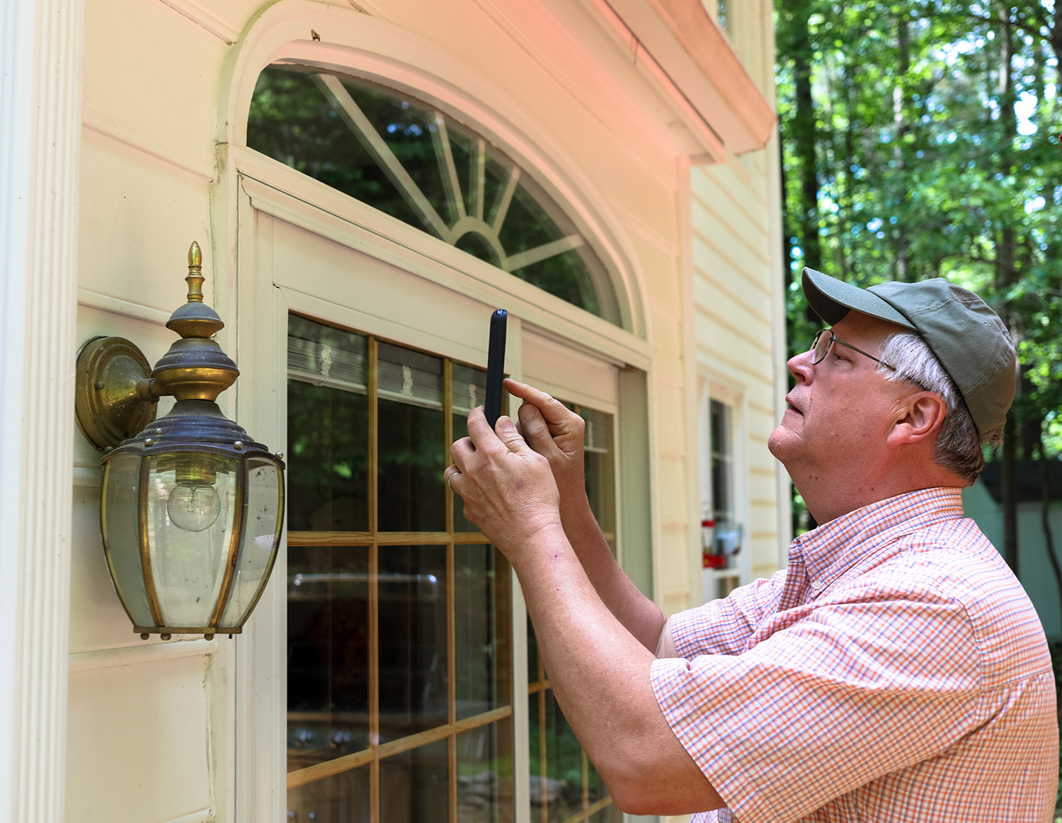 Our licensed home inspectors, Mark, inspecting the outside of a house